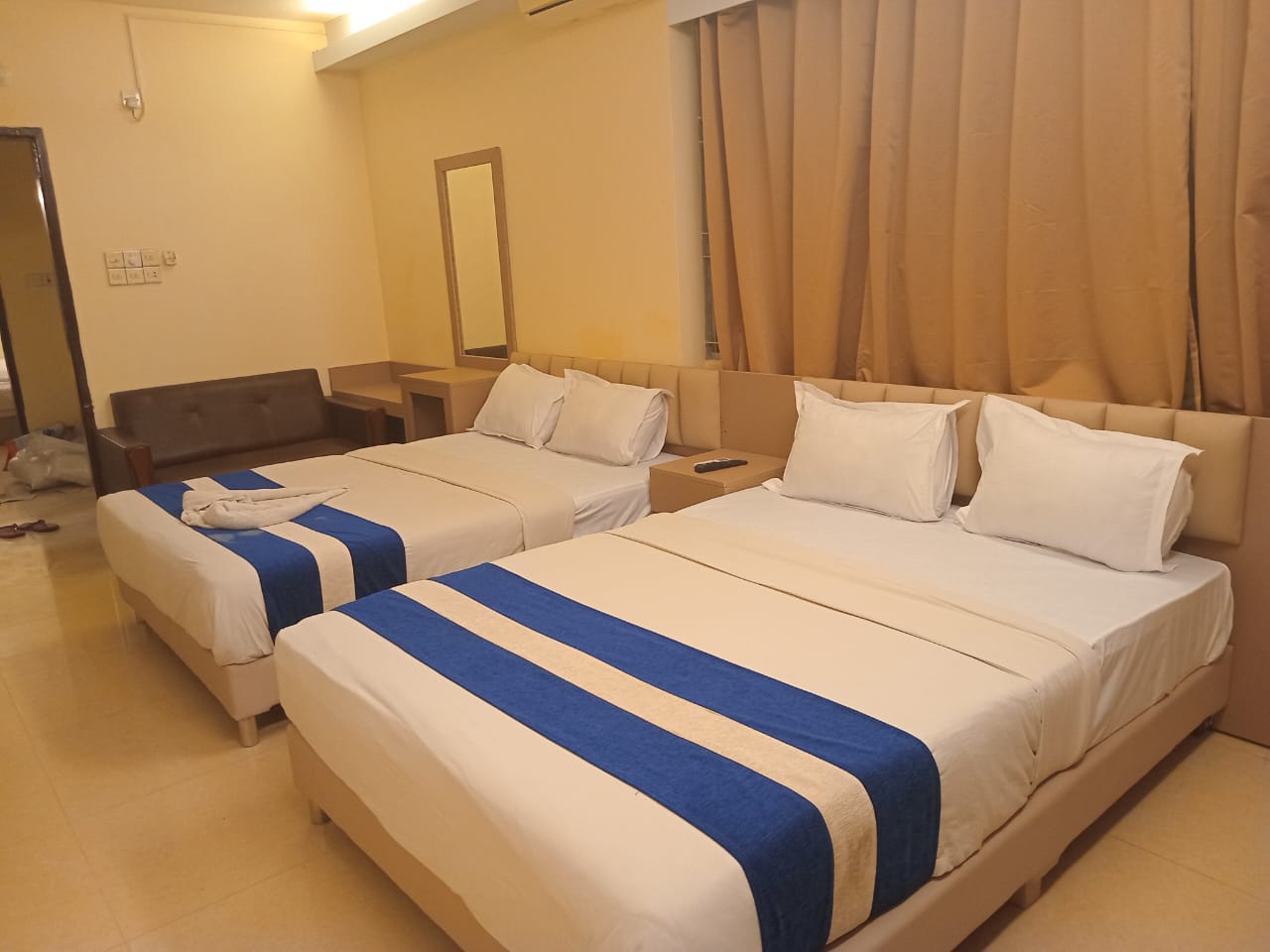 Luxury King Room with City View – Modern Hotel Accommodation Modern deluxe hotel room with king-size bed, city view, and stylish interior decor