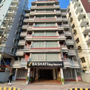 Front view of Bashati Bay Resort building with balconies and signage.