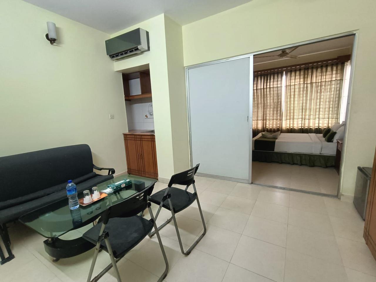 Hotel Suite with Separate Lounge and Bedroom Hotel suite with a seating area and bedroom separated by sliding glass doors.