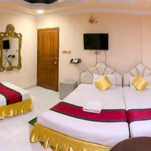 Triple-bed room with modern decor at Reyadha International Hotel near Sugandha Point, Cox’s Bazar