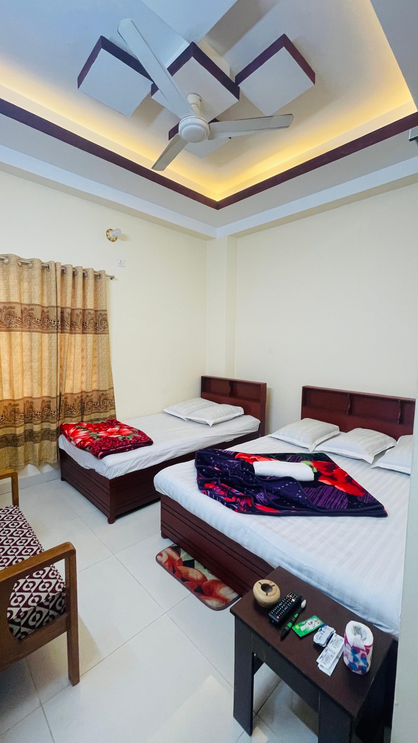 Spacious Hotel Room in Cox’s Bazar - Ideal for Your Stay Comfortable hotel room with two beds, modern decor, and a ceiling fan in Cox’s Bazar.