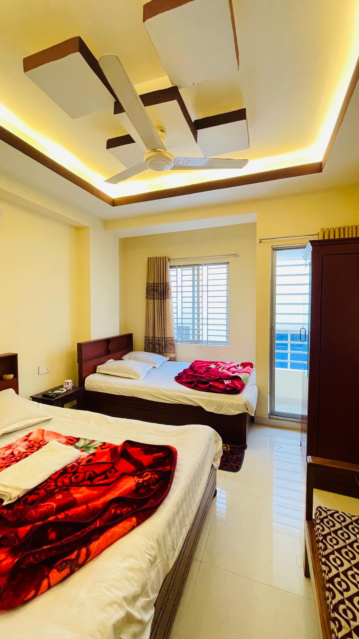 Modern and Cozy Hotel Room in Cox’s Bazar for Your Comfort Hotel room in Cox’s Bazar with modern lighting, ceiling fan, and cozy bedding.