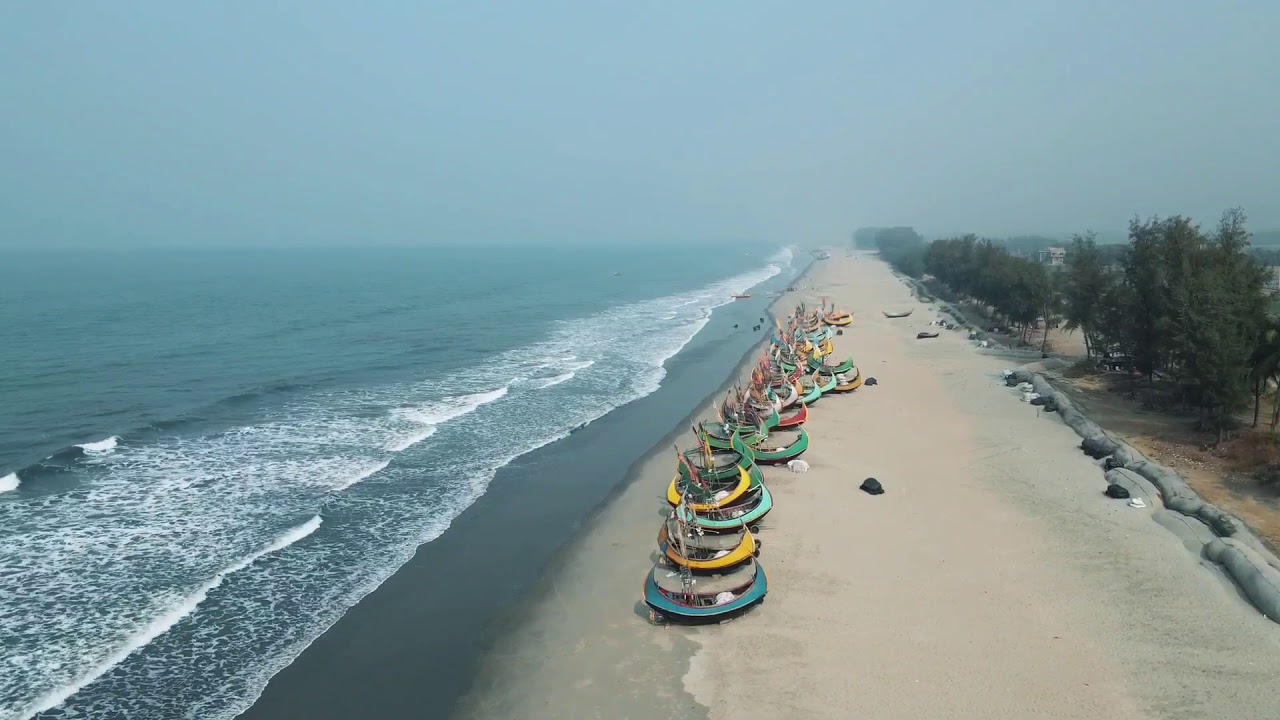 Fishing boats on the serene sea at Cox's Bazar, the world's longest natural sea beach.